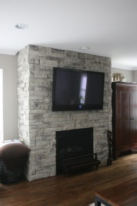 Gray Mountain Ledgestone fireplace veneer with a TV