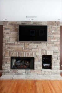 Cobble Stack stone veneer fireplace with gaming console storage