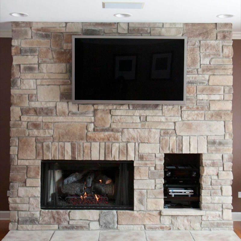 Cobble Stack stone veneer fireplace with gaming console storage