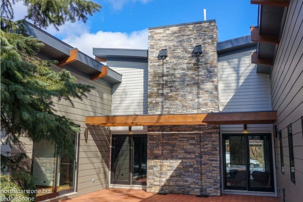 stone veneer chimney on leed house