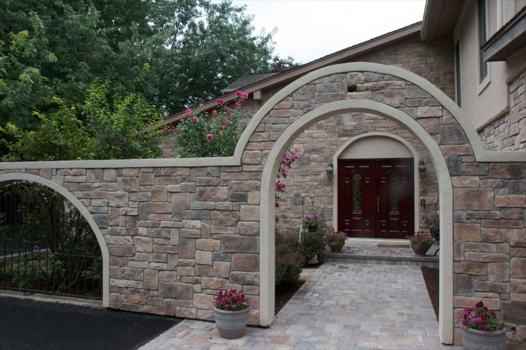 Home with a stone veneer arch