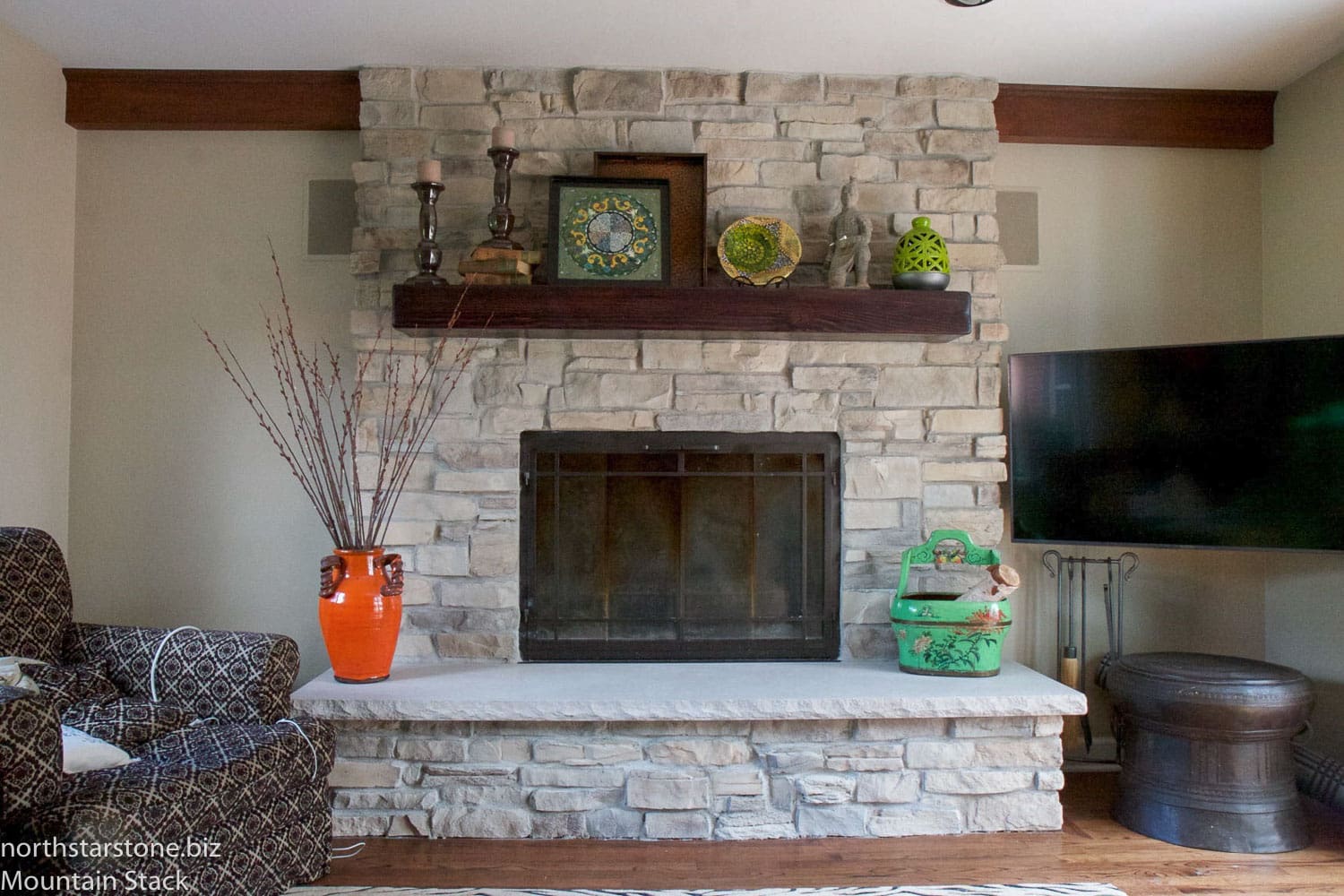 home with a mountain stack stone veneer fireplace