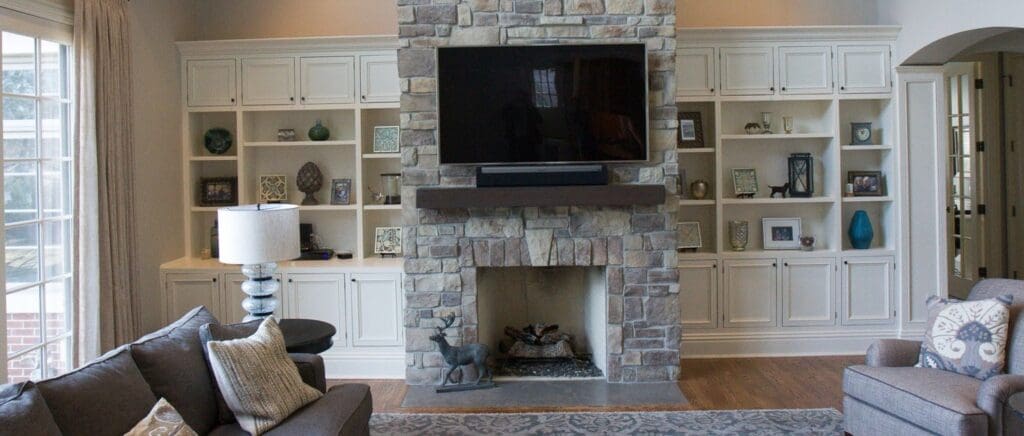 Decorative fireplace idea with stone veneer and a TV